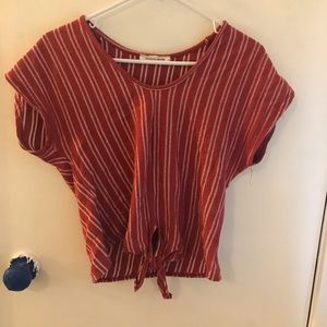 Red striped crop shirt with tie in the front.